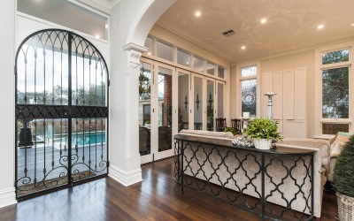 Wrought iron and glass doors. Created for this project these doors look more like a gate to the outside but provide warmth and security and maintain the inside/outside "flow".  Notice that the wrought iron work is consistent with the bench to the right and also is sympathetic to the look of the leadlight windows in the background.